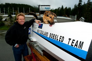 Martin White olympic contender and his temporary bobsled crew member -dog Harley -polishing the sled